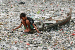 Boy in Boat in Polluted Water